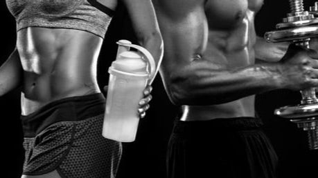 Two people in athletic wear, one holding a protein shaker, against a black background.